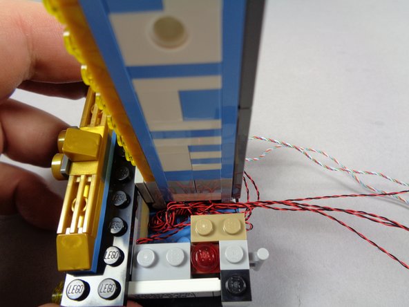 The wires for the marquee light sections may be longer than needed for your setup.  If so, you can coil up the excess wire on either side of the top marquee section, inside the base, before re-attaching the top side sections.