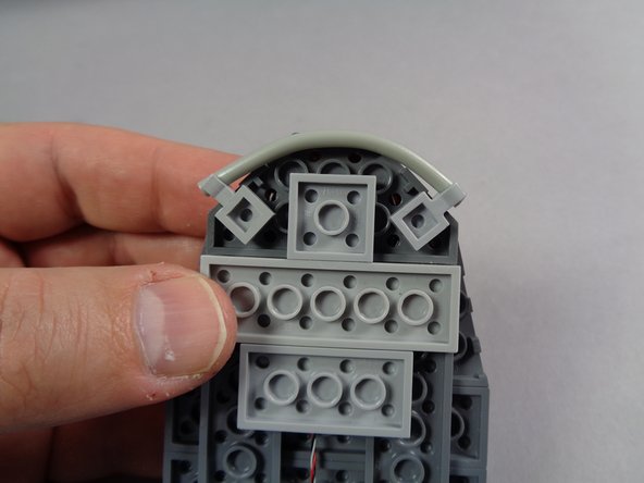 The red circle in the first photo shows how the control wire for the eye assembly should pass UNDERNEATH the light bluish gray 2x4 plate.  Make sure the wire is never pinched between studs.
