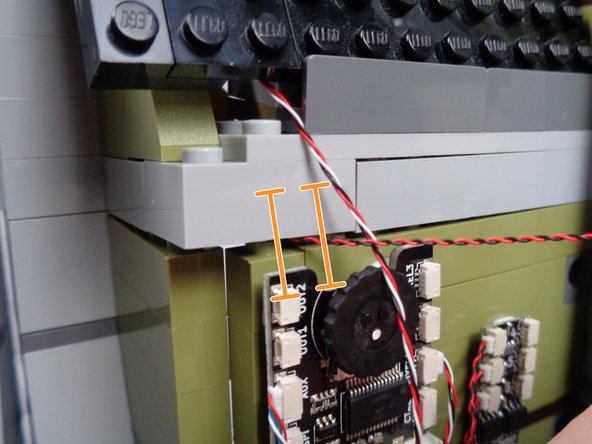 Gently press down on the light bluish gray bricks at the base of the roof, so they begin to go back into place.