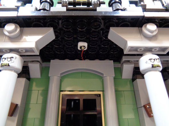 As shown in the second photo, mount the yellow Pico LED light on the porch ceiling in front of the front doorway.