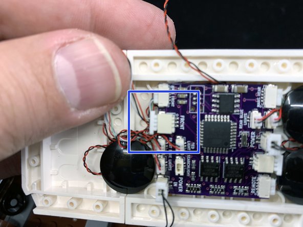 As shown by the red circles in the first photo, insert the two black power wires into the two large connecting plugs under the roof.