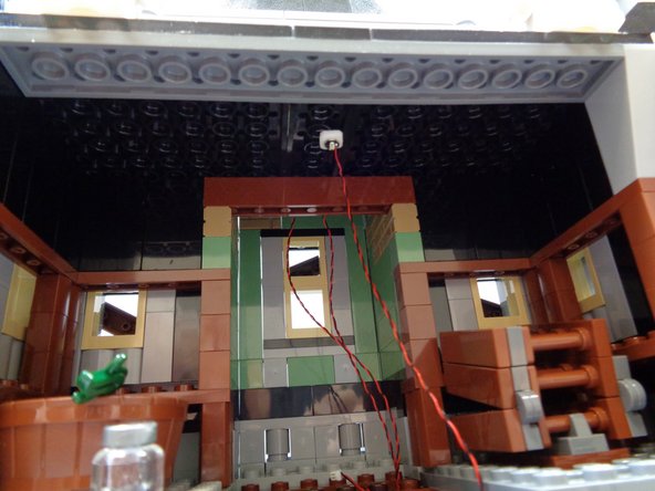 As shown in the first photo, attach the green light to the center of the attic ceiling.