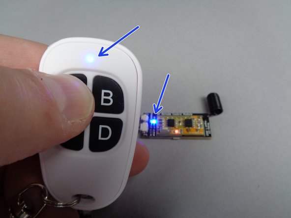 The remote uses radio frequency to communicate, so it will work over long distances and through obstacles such as walls and display cases.