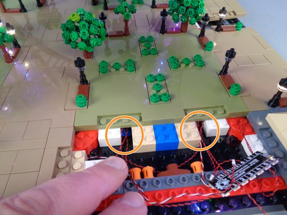 As shown in the first photo for this step, position Panel 2 to be re-attached but do not press down yet.