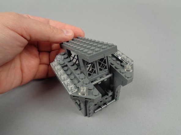 As shown in the photos for this step, finish disassembly by removing the large center plate and windows beneath.