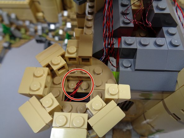 As shown by the red circle in the second photo, make sure all wires under the top tower section run between, not on top of studs when re-attaching the top.