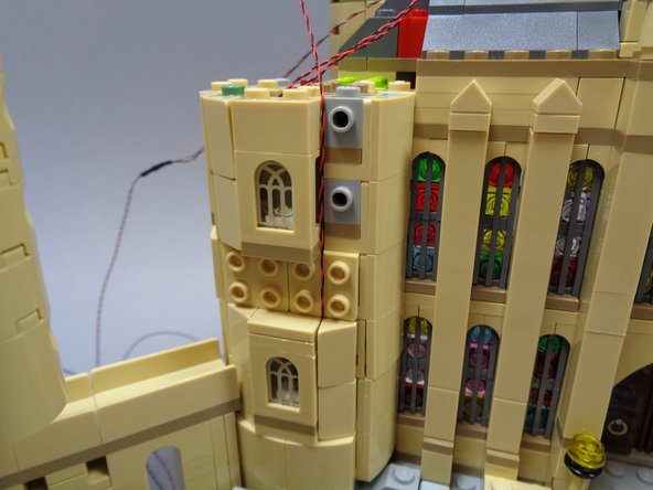 As shown in the second and third photos, re-attach the parts surrounding the lower window.