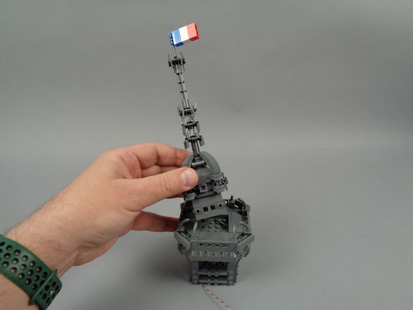 As shown in the first photo for this step, re-attach the center antenna section.