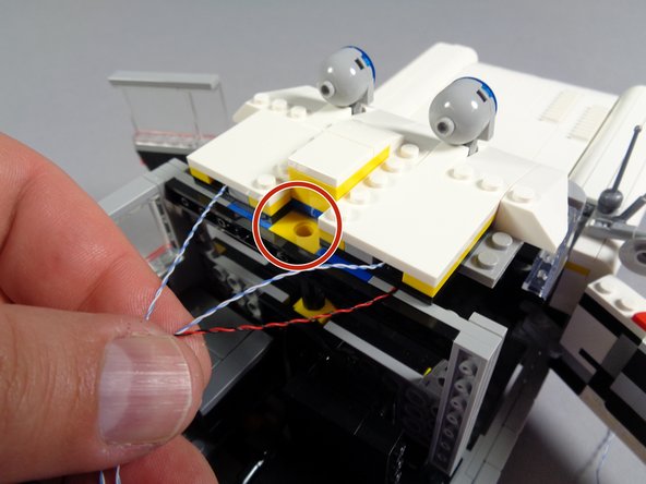 As shown in the first photo for this step, carefully re-attach the front roof section.  Press down on the front first, re-attaching the roof to the top of the windshield.