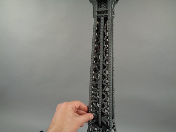 As shown in the photos for this step, attach the top of strip #2 to the tower frame, and re-position brace elements as needed to make room for the LED lights and strip.