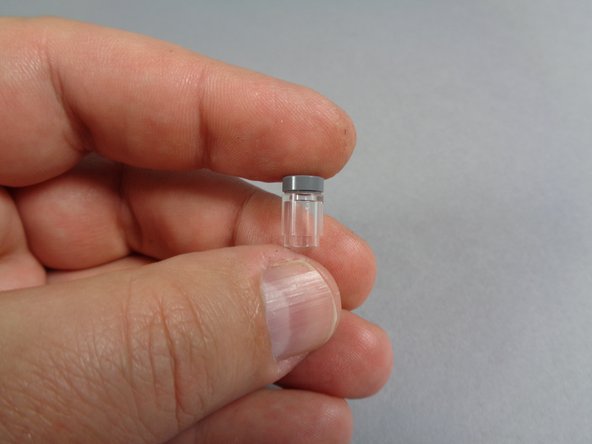 As shown in the third photo, place the round silver tile on top of the round transparent brick.