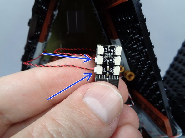 As shown by the blue arrows in the first photo for this step, connect both candles to plugs #1 and #2 on the third BRANCH06X adapter board.