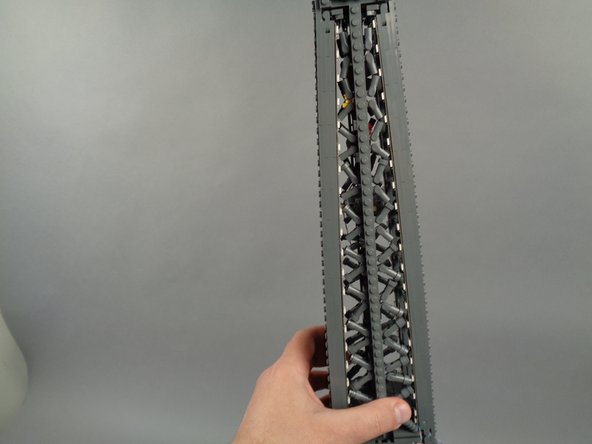 As shown in the photos for this step, attach the top of strip #1 to the tower frame, and re-position brace elements as needed to make room for the LED lights and strip.