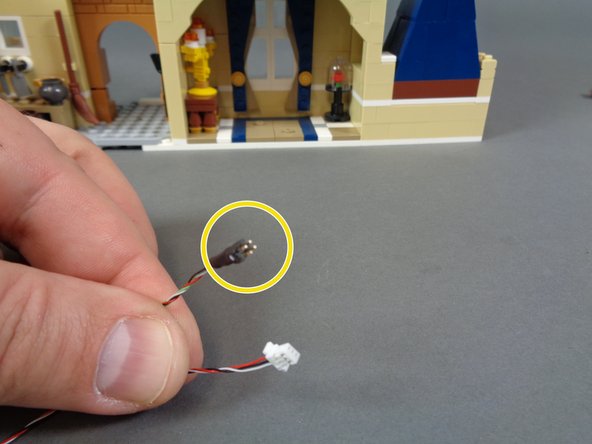 As shown in the second photo, there is a special wire inside the &quot;Middle Level Lights and Parts&quot; bag that has a large white plug on one end and a small black plug with gold pins and a white dot on the other end.