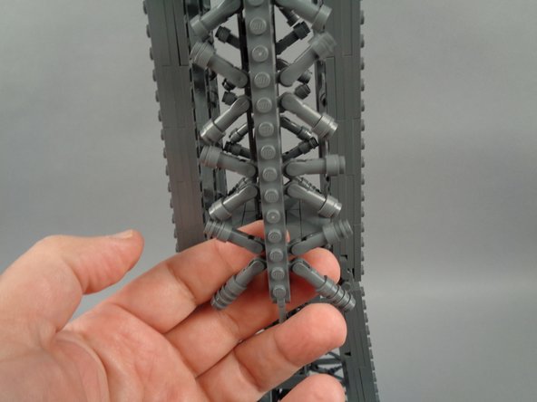 As shown in the photos for this step, next you will remove the top rear panel section above where you removed the lower rear section earlier.