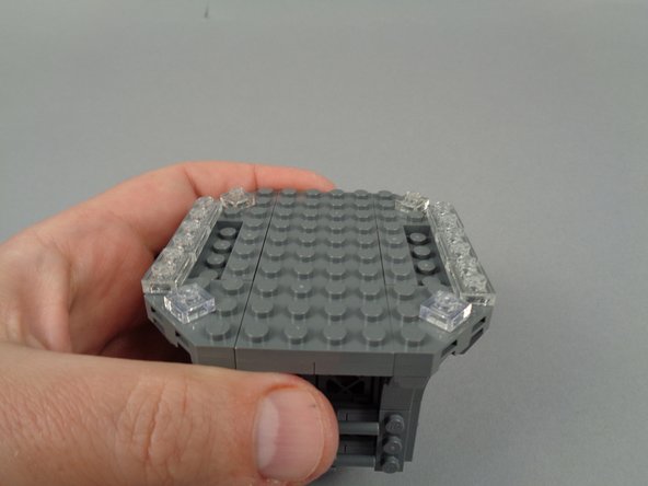 As shown in the photos for this step, remove the six clear 1x2 plates on either side of the top center.