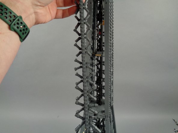 As shown in the photos for this step, next you will remove the top rear panel section above where you removed the lower rear section earlier.