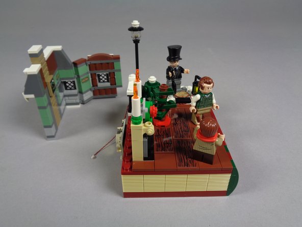 As shown in the photos for this step, you should be able to bend and then lift off the entire wall section of the house.