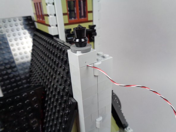 Make sure you are re-attaching the section of the chimney located on the same side of the mansion as the front door, as shown in the first photo.