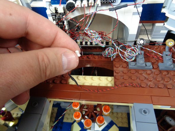 Run the chandelier light wire back toward the TRUNK08 master controller as shown in the first photo.