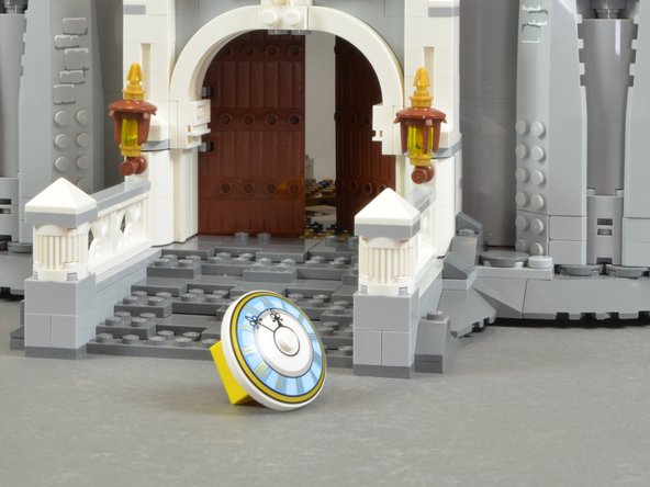 As shown in the first photo for this step, remove the clock and the red and yellow LEGO parts holding it in place.