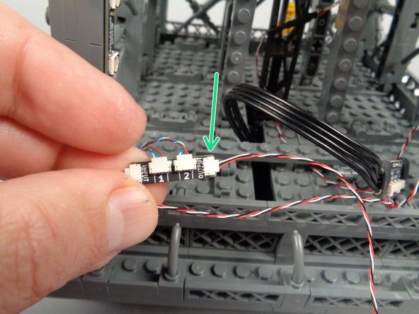 Take another 3-wire control cable, and as shown by the green arrow in the first photo for this step, connect one end of it to the OUTPUT plug on the adapter board for the pair of light strips you just finished mounting.