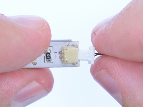 Once the light strip is securely mounted, attach the connecting cable.