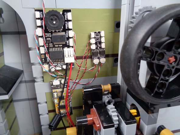 If needed, take a moment to tidy up any loose wires as shown in the second photo.  Make sure there is no loose wire that could later become caught on any gears.