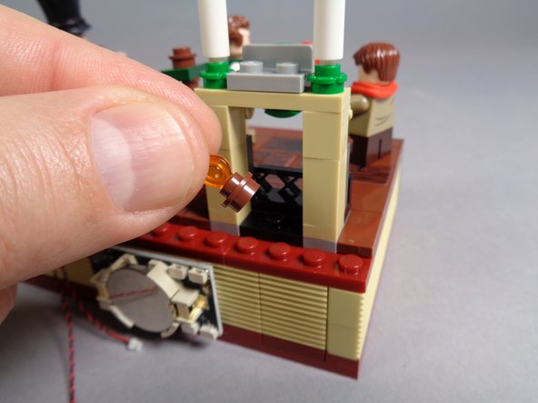 As shown in the first photo, remove the fireplace flame assembly from inside the fireplace.