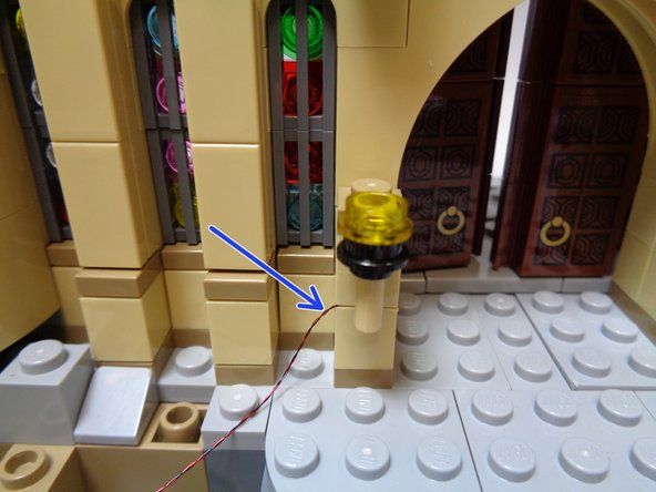 As shown in the first photo, mount the torch with the pre-mounted light where you removed the torch in the previous step.