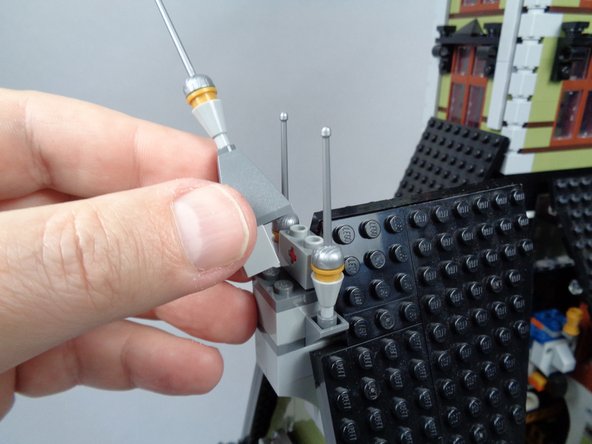 As shown in the photo for this step, remove the center pyramid piece from the center of the front roof to make room for the second rooftop lightning LED light.