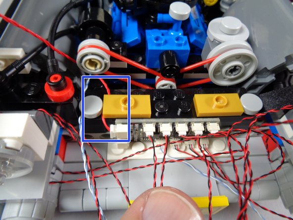 As shown in the first photo for this step, remove the gold 1x2 jumper plate from the engine frame.