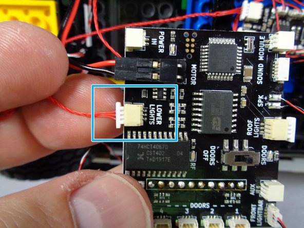 As shown by the blue rectangle in the third photo for this step, connect the other end of the red wire to the LOWER LIGHTS plug on the main controller.
