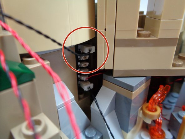 As shown in the second photo, take the 12&quot; connecting cable attached to the top of the BRANCH15 adapter you mounted earlier.  This is the adapter to which the lights from Umbridge's Office and the Defense Against the Dark Arts Classroom are connected.