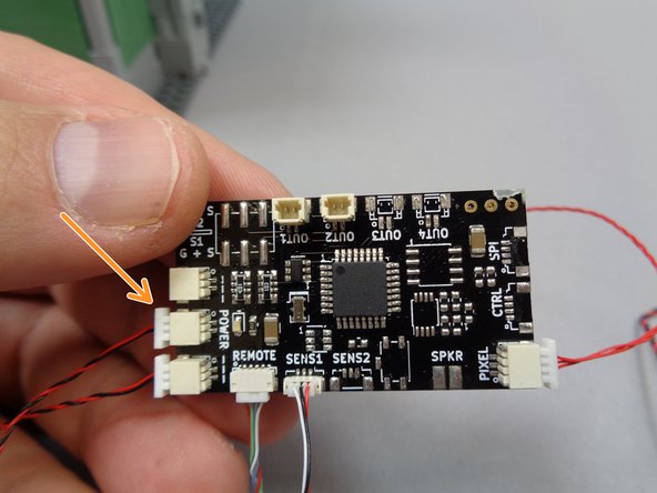 As shown by the orange arrow in the third photo, connect the red/black power wire from the sound module to one of the &quot;POWER&quot; plugs on the TRUNK08 master controller.