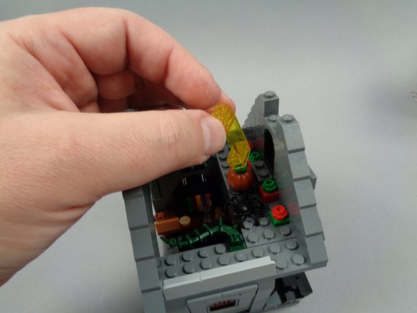 As shown in the photo for this step, remove the transparent yellow attic window.