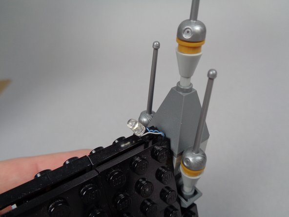 Re-attach the pyramid-shaped roof piece you removed to make room for the lightning LED light.