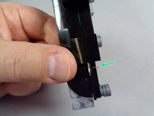 As shown by the green arrow in the first photo, carefully pull the LED light wire down from underneath the dashboard until the small light at the end of the wire is positioned just above the speedometer tile.