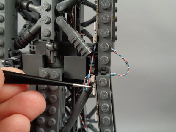 As shown in the photos for this step, you can use the tweezers to tidy up any visible sections of wire connecting the 17-LED sections and 20-LED sections of both light strips.