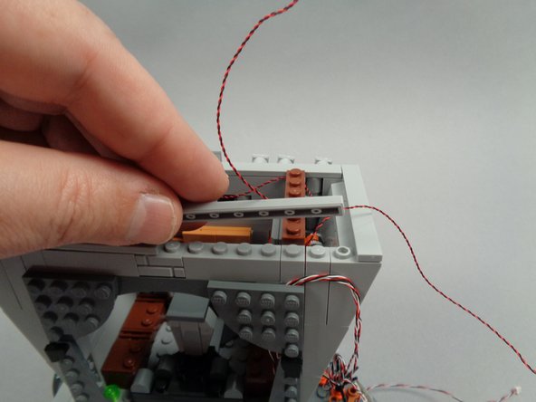 As shown in the first photo for this step,  remove the long tile on the right rear side of the hall.