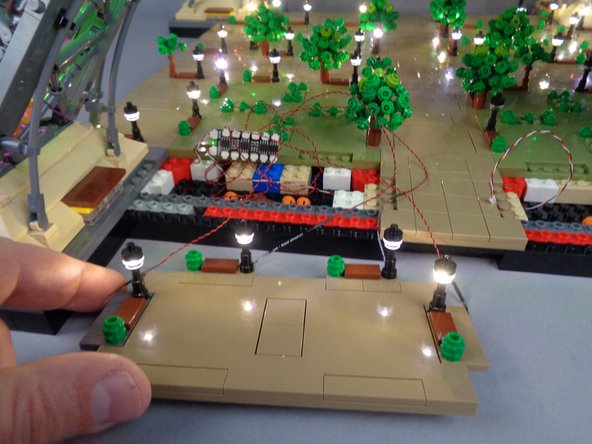 As shown in the second photo for this step, connect the four lamp posts to the final four open plugs on the BRANCH12X driver board, and verify that all lamp posts in Section 3 are working.