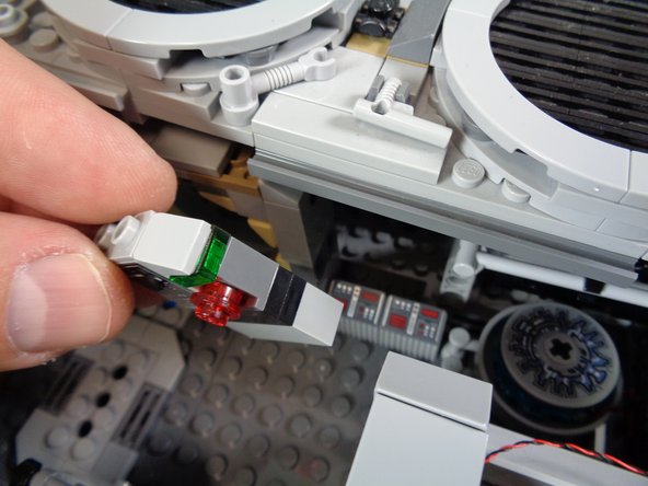 As shown in the photos for this step, remove the control panel from the interior area near the hyperdrive and mount a Pico LED light through the hole in the dark bluish gray brick.