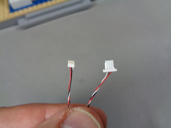 Inside the &quot;Lower Level Lights and Parts&quot; bag, there will be a custom cable with connectors on each end like the ones shown in the first photo.  One end will have a small 3-wire plug and the other end will have a large 3-wire plug.