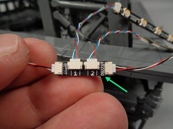 As shown by the green arrow in the photo for this step, connect another 3-wire control cable to the OUTPUT plug on the adapter board.