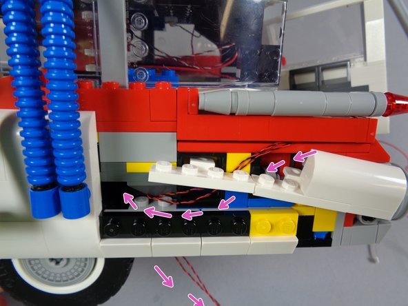 The process and path for passing the wires for the left tail lights is the same as for the right.  As with the right side, having a flashlight and tweezers may help make it easier to pass the wires.