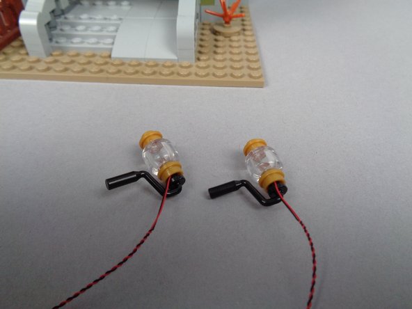 The third photo in this step shows what both front porch lights should look like after you have re-assembled them with the Brickstuff pre-lit bases.