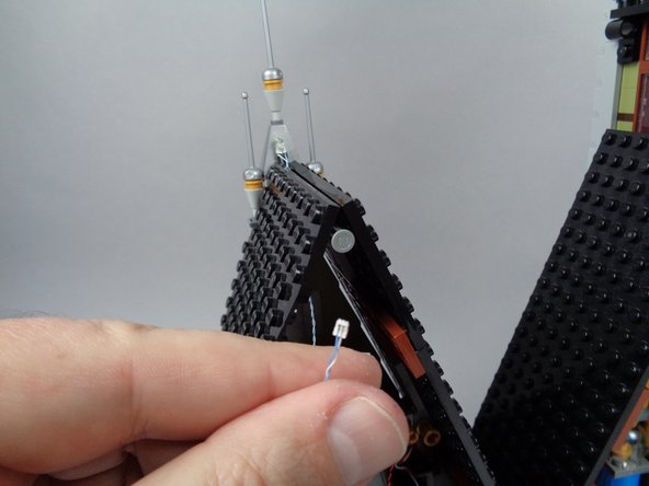 As shown in the third photo for this step, you should have the plug for the rooftop lightning LED light accessible.