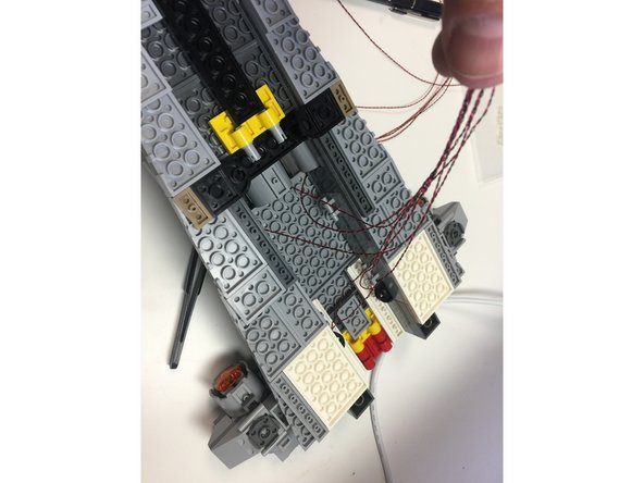 As shown by the photos in this step, coil up any excess wire coming from the seven center engines and connect all LED wires to the BRANCH10 adapter board from Bag 4.  Connect one of the 12&quot; connecting cables from Bag 4 to one of the large connectors on the BRANCH10 adapter board.