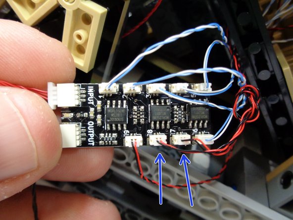 As shown by the two blue arrows in the second photo, connect the wires for the two cool white lights to plugs #7 and #8 on the BRANCH09X adapter board.