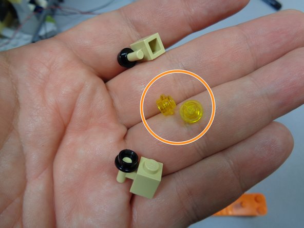 As shown in the second photo, you can use two 1x1 round transparent yellow plates from the lanterns you replaced during the lighting installation to mount the BRANCH09 adapter board to the inside of the tower.